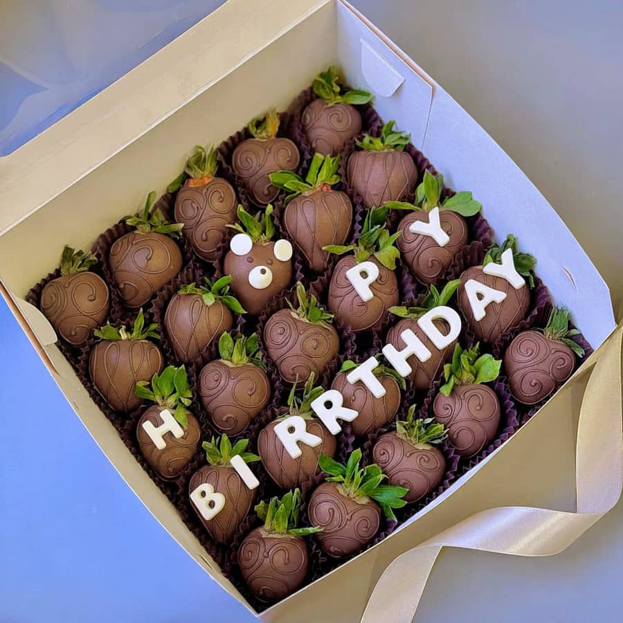 Chocolate covered strawberries with Happy Birthday lettering in a gift box for a birthday